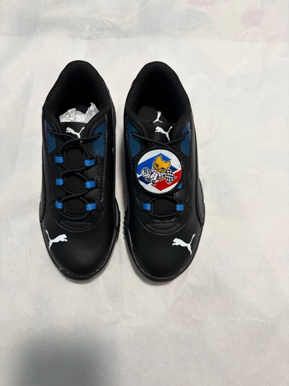 Puma Kids Black Sneakers with Blue Accents and Racing Patch